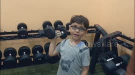 child plays weight training exercises in Gaza City