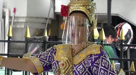 Thai dancers wear Covid-19 face shields at Buddhist shrine