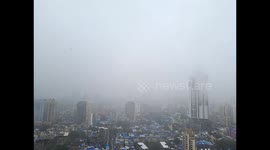 Tall buildings covered by mist and heavy rain in Mumbai city