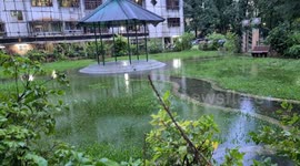 Waterlogging in an apartment garden due to heavy rains in Mumbai city creating a pond like view