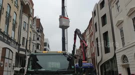 Crane Lifting A Huge Glass In Conduit Street
