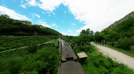 Acrobats perform mind-blowing jumps from a trampoline suspended from the world’s longest stone arch bridge