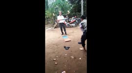 Street performer manipulates ring of fire with his feet in Vietnam