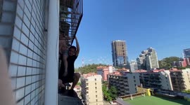 Chinese man holds up 4-year-old boy hanging from fifth-floor window