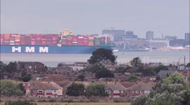 Huge container ship HMM Gdansk departs the Thames, UK