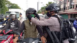 The Mobile Brigade Police Unit (BRIMOB) distributed 2 thousand masks to residents driving on the Jakarta kwitang highway during the COVID-19 pandemic