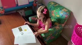 Little girl reads a book