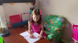 Little girl writes