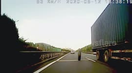 Tyre crashes into car after falling off truck in China