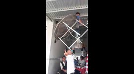 Vietnamese entertainer uses mouth to balance table with child on it