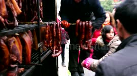 Chongqing residents smoke bacon despite local ban