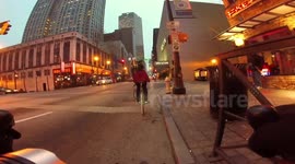 Street busker plays amusing theme music for cyclist