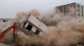 Near-miss during risky building demolition in China