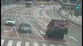 Overloaded tipper truck loses balance in China