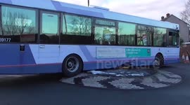 Bus grounded on a roundabout in Manchester, UK