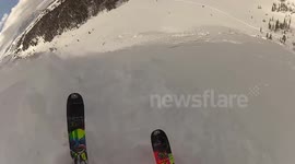 Skier triggers avalanche and rides it out