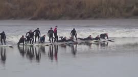 Surfers ride Severn Bore in Gloucestershire, UK