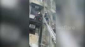 Fire personnel rescue people trapped after massive fire breaks out in seven-storey building in western India