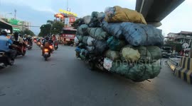 Severely overloaded tricycles carrying tons of trash in Vietnam, It was like a giant truck