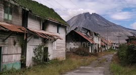 Abandoned village gloomily sits in the shadow of active volcano on Mount Sinabung