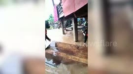 Homes partially submerged by floodwater as heavy rain cause flash floods in northern Thailand