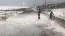 UK: Sea Foam Blankets Tywyn Beach In Wales As Storm Francis Hits
