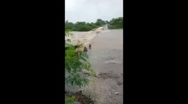 Terrifying moment truck swept into fast-flowing river during heavy floods in India