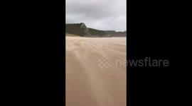 Strong winds from Storm Francis viciously blows sand away in Oxwich Bay
