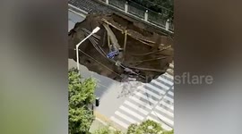 Huge sinkhole opens up on road in South Korea after 'water pipe bursts'