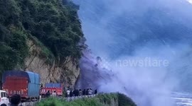 Mud and trees tumble down from mountain, blocking traffic on Chinese road