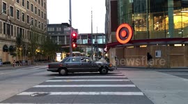 A Man Stops To Take Photos Of Downtown Minneapolis Target After Curfew