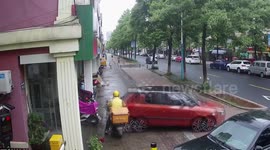 Car reverses into deliveryman and pushes him into shop after Chinese motorist with heels accidentally presses accelerator
