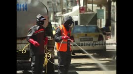 Palestinian workers spray disinfectant on roads and buildings as Gaza lockdown continues