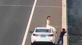Chinese couple take their wedding photos on highway