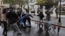 South African police and gender violence protesters clash in front of parliament