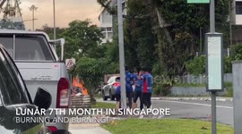 Burning Paper in Large bin by Roadside Lunar 7th Month in Singapore