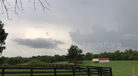 Incoming storm clouds roll in over the field