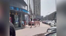 Naked Chinese workers run along road after they lose competition with colleagues