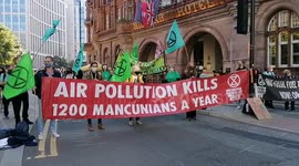 Extinction Rebellion block streets in centre of Manchester, UK