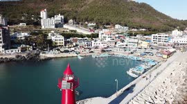 Lighthouse in Haeundae harbour in Busan, South Korea by drone