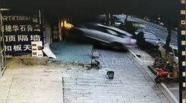 Car smashes through shop's shutter in southern China