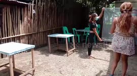 Partygoers do the cha-cha while using plastic sheet to follow Covid-19 distancing rules