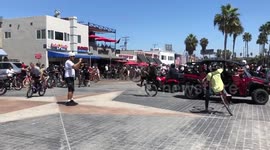 Bicyclist almost crashes into cop after popping wheelie in San Diego