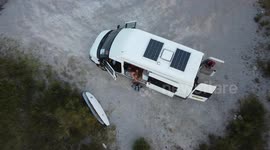 Droneshot of young woman sitting in van in France #vanlife