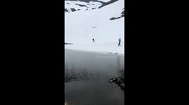 Man tries to ski over a pond, almost succeeds and fails in the end