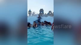 Chinese man on inflatable dolphin flies over crowds at water park's wave machine