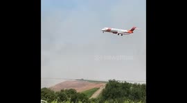 Air Tanker throwing retardant on fire in Buelton,