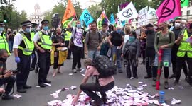 'Blood Money' thrown up in the air outside 10 Downing Street at Carnival of Corruption by Extinction Rebellion