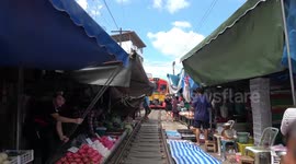 Famous train line that runs through a Thai market free of crowds