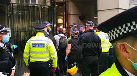 Extinction rebellion protester who glued his had to the windows of the department for transport building
